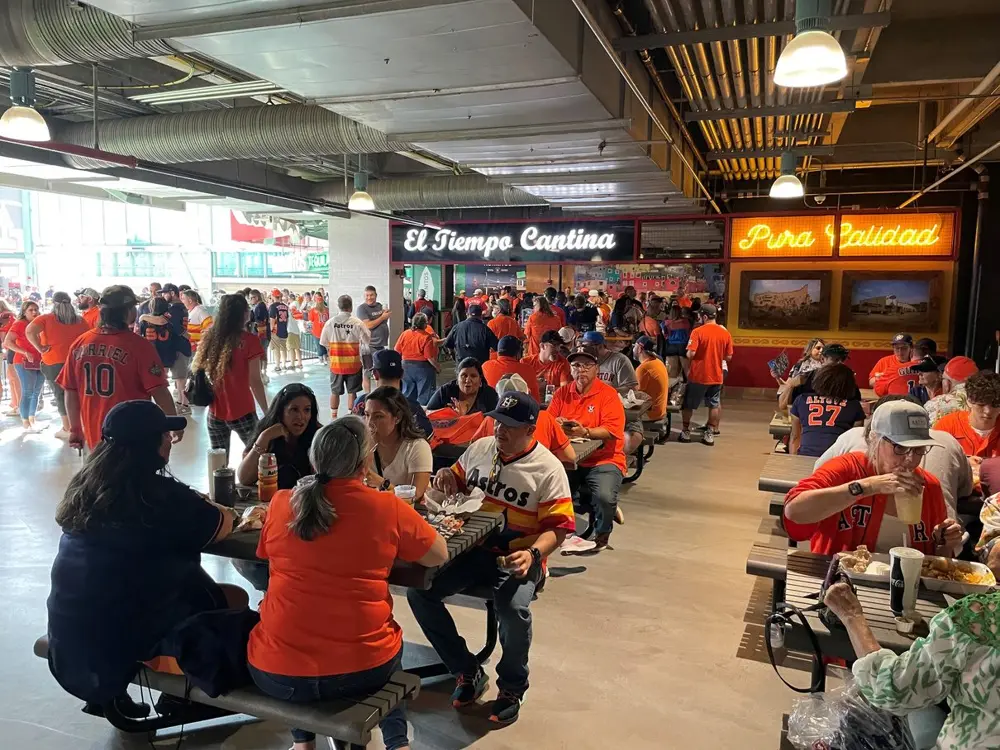 Astros fans crowding the El Tiempo Cantina concession at the ballpark