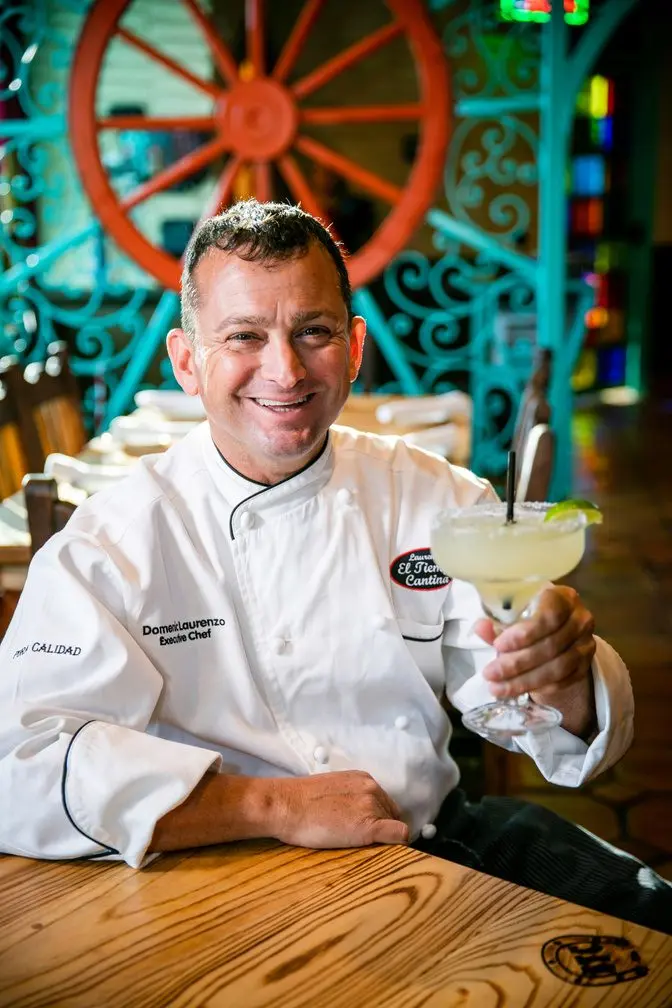 Domenic Laurenzo seated in the dining room with a margarita