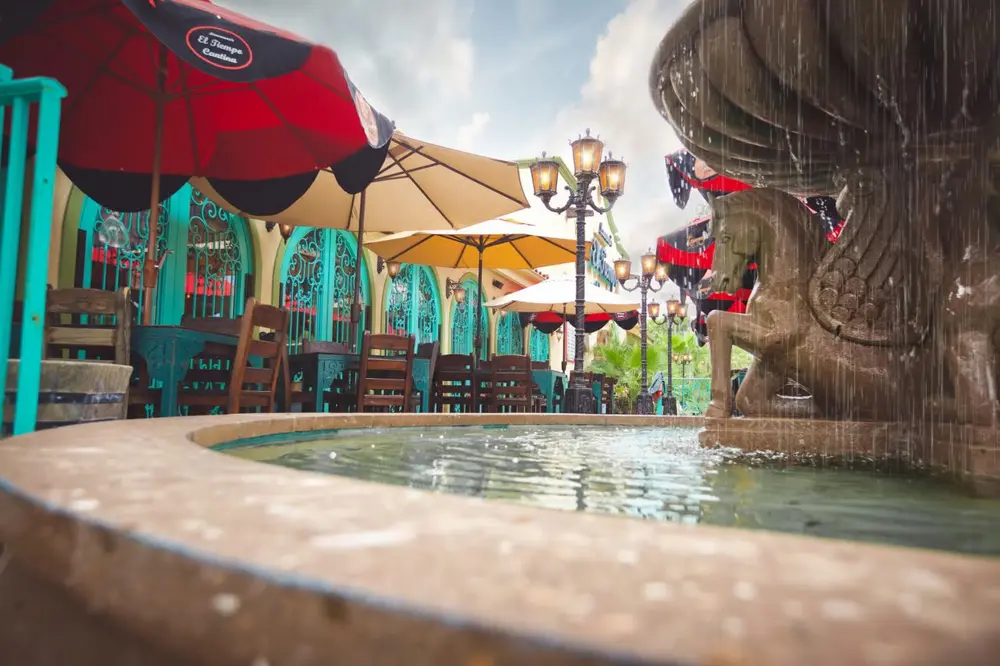 Fountain and umbrella-shaded patio at El Tiempo Navigation