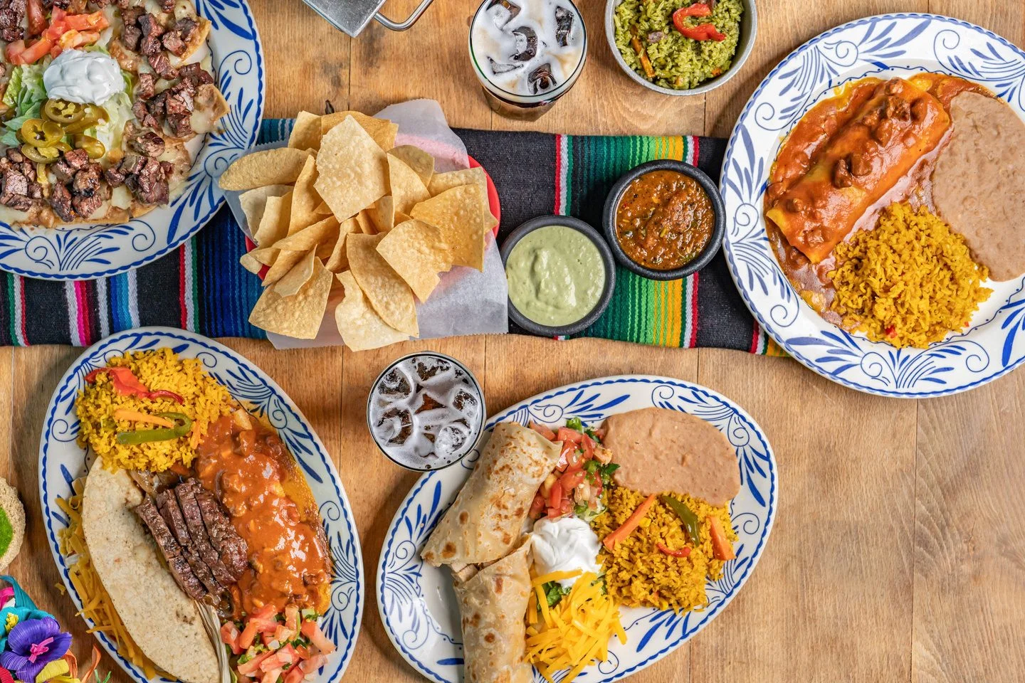 A table filled with El Tiempo’s signature Tex-Mex dishes, fajitas, and fresh salsas